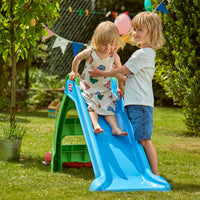 Load image into Gallery viewer, Two children playing on a blue slide in a garden setting with greenery and balloons.