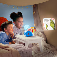 Load image into Gallery viewer, Two children sitting on a bed with a nightlight and a book featuring a character from 'How the Grinch Stole Christmas'.