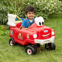 Load image into Gallery viewer, Child playing with a red toy fire truck in a grassy area