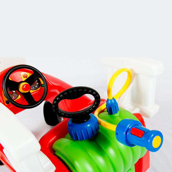 Colourful toy fire truck with steering wheel and water gun attachments on a white background