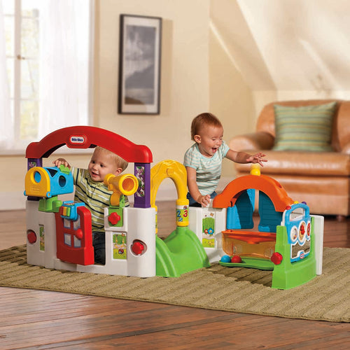 Children playing with a colourful playset in a living room.