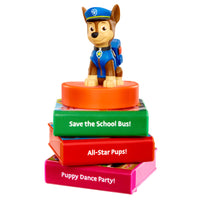 Load image into Gallery viewer, Toy figure on a stack of colorful books with text, on a white background
