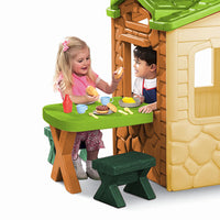 Load image into Gallery viewer, Children playing with a toy playhouse and table set on a white background
