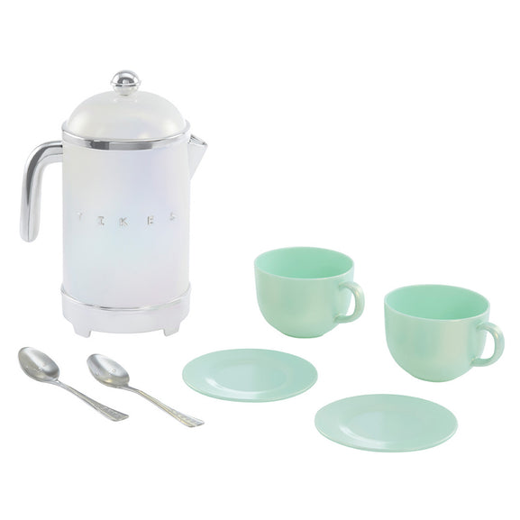 A retro-style ceramic coffee pot with a white body and silver accents, accompanied by two mint green cups with saucers and two silver spoons, arranged on a clean white background.