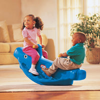 Load image into Gallery viewer, Two children playing on a blue toy rocker in a living room.
