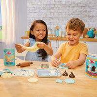 Load image into Gallery viewer, Children playing with cookie dough play set using cookie cutters on a wooden table in a kitchen setting

