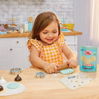 Load image into Gallery viewer, Child using a rolling pin to flatten cookie play dough mix
