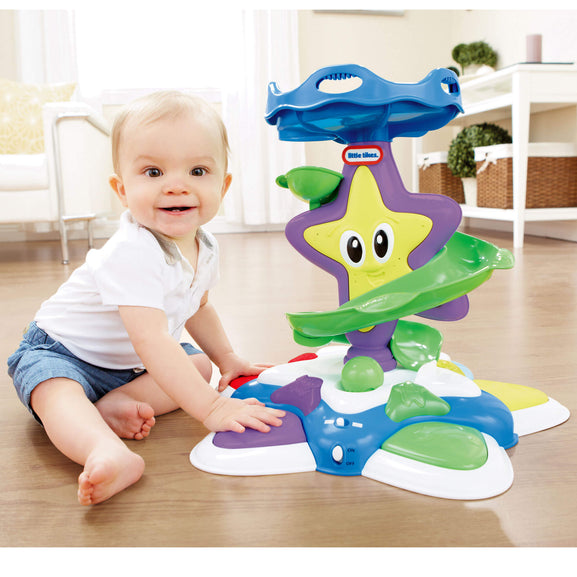 baby sitting playing with Stand ‘n Dance Starfish