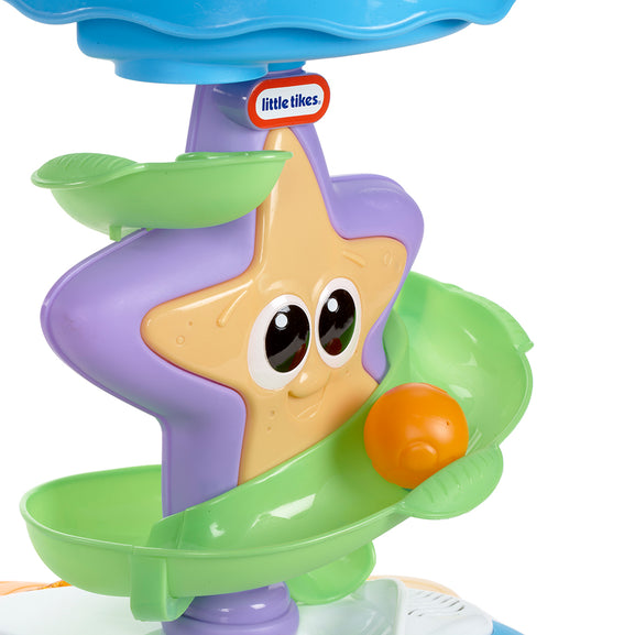Toy starfish with a purple shell and green body, featuring the Little Tikes logo.