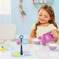 Load image into Gallery viewer, Young girl playing with a toy tea set 
