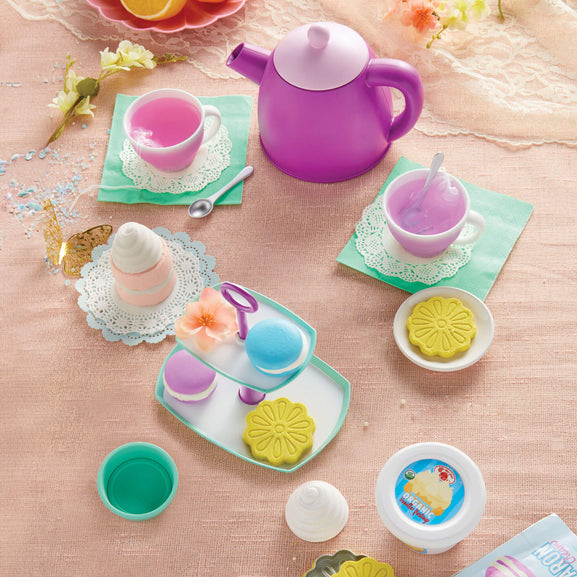 Colorful toy tea set with a purple teapot and cookies