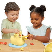 Load image into Gallery viewer, Two children playing with a yellow toy duck on a wooden table.
