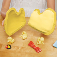 Load image into Gallery viewer, Yellow duck-shaped mould with silicone shapes on a wooden surface

