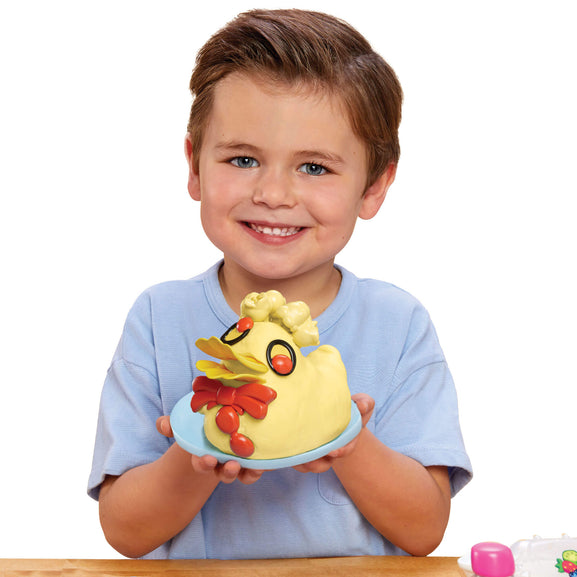 Child holding a colourful Bluey duck cake against a white background