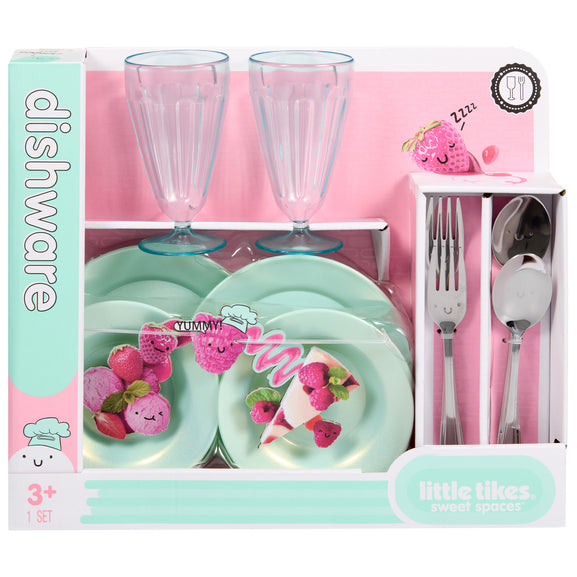A children's dinnerware set in a pink and mint green box labeled 'dishware' and 'little likes sweet spots'. The set includes two clear ribbed drinking glasses, two mint green plates, a silver fork, spoon, and knife, and decorative fruit-and-dessert illustrations printed on the packaging.